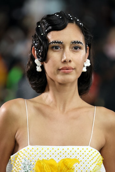 The best NYFW beauty looks include pearl eyebrows as seen on model walking the runway for Deus Ex Ma...